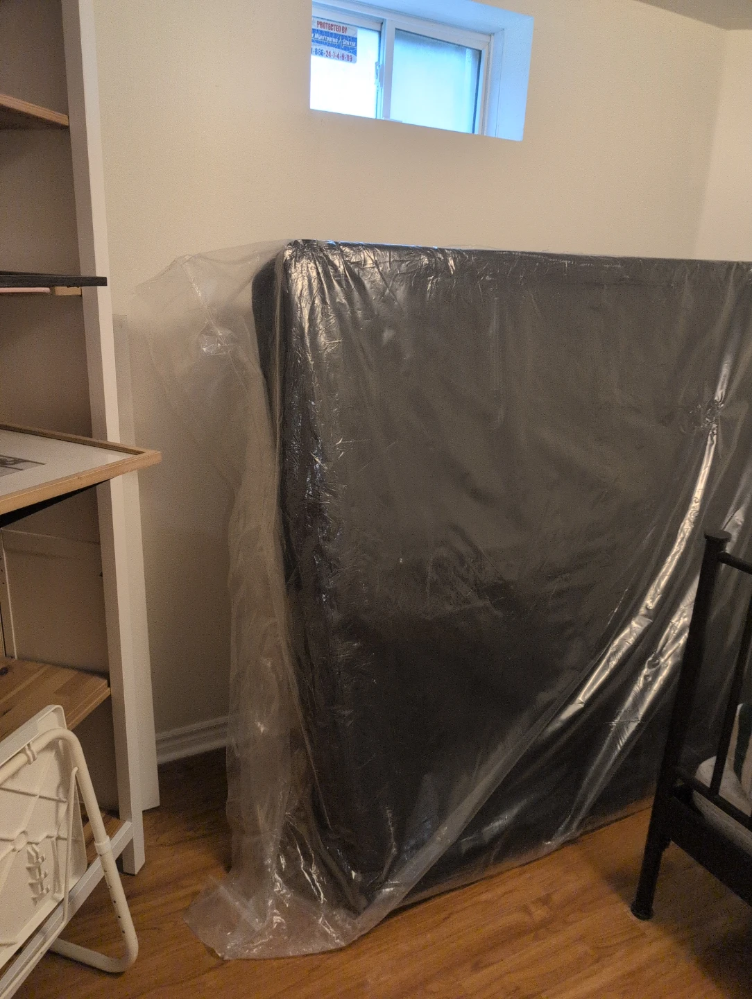 Mattress in protective plastic wrapping