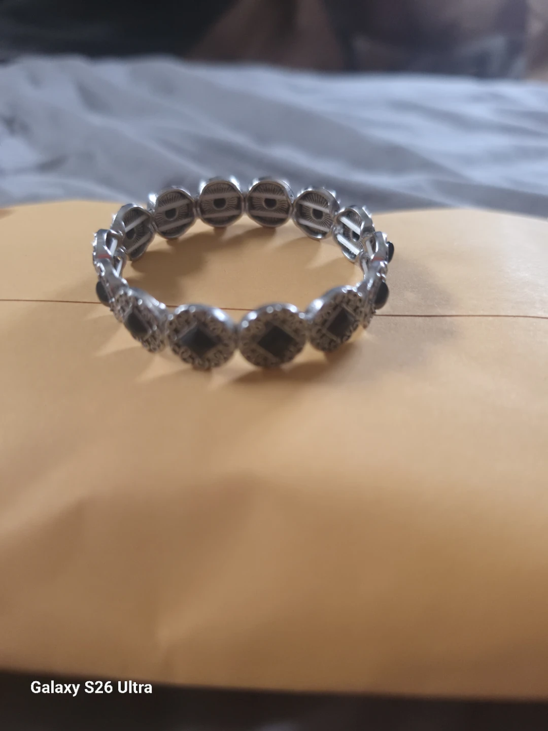 Silver tone stretchy bracelet with black accents