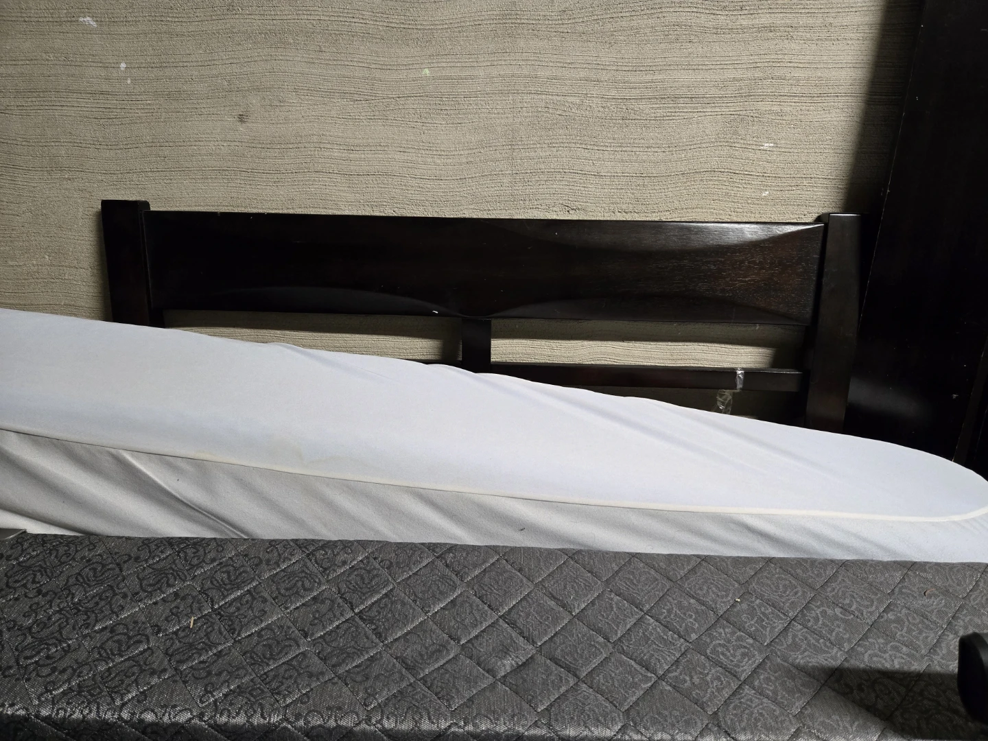 Blue Quilted Mattress Topper twin XL and  a brown twin bed frame