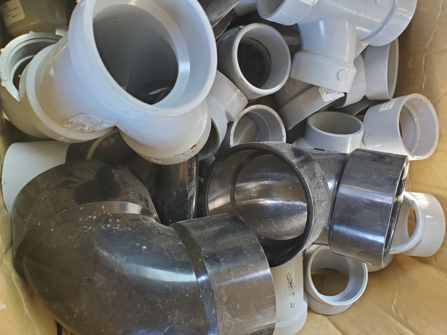 Assorted PVC and Cast Iron Plumbing Fittings
