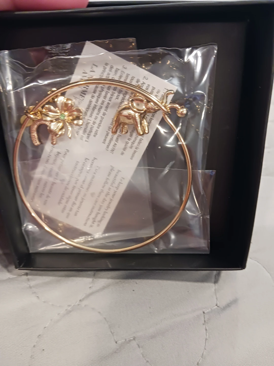 Gold-tone Bangle Bracelet with Elephant and Clover Charms