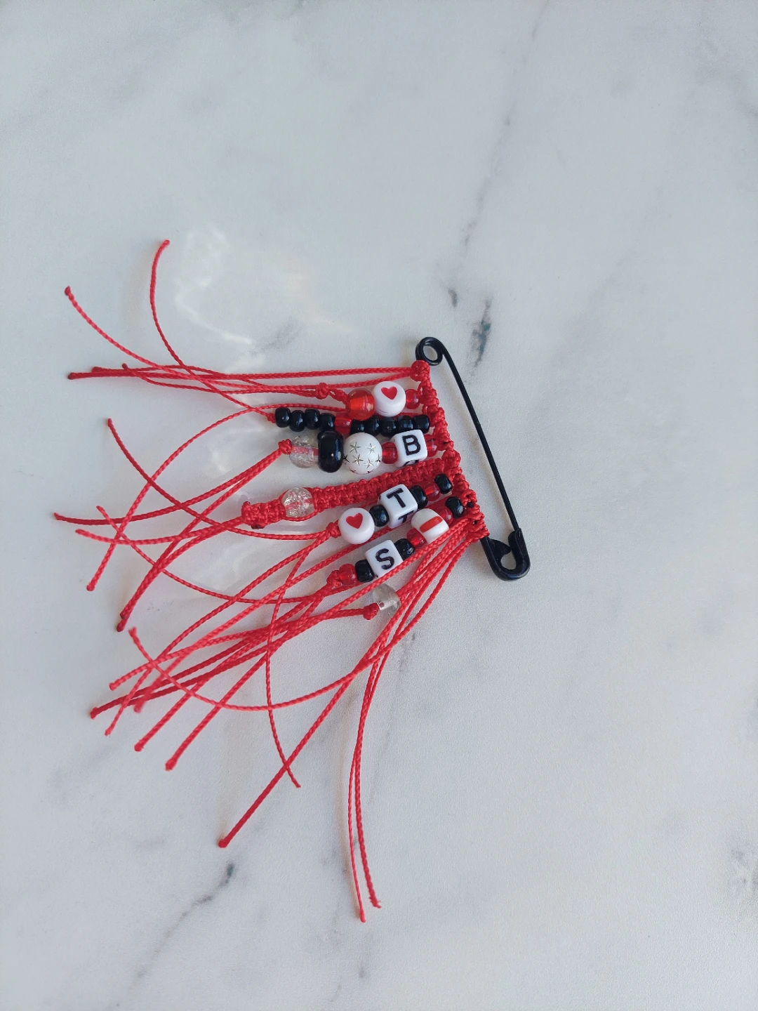 2" black safety pin with red tassel/macrame drop and BTS