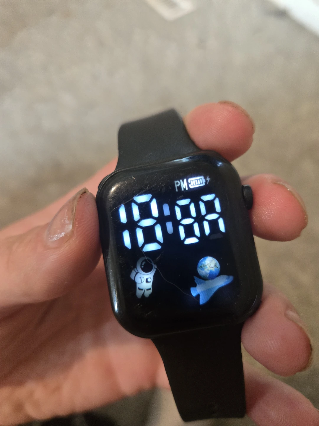 Digital Watch with Astronaut and Plane Graphics