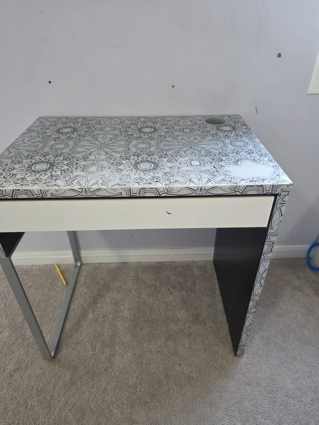 Desk with patterned top and drawer