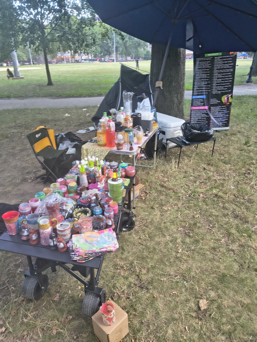 Variety of drinks and cups at outdoor event - photo 2