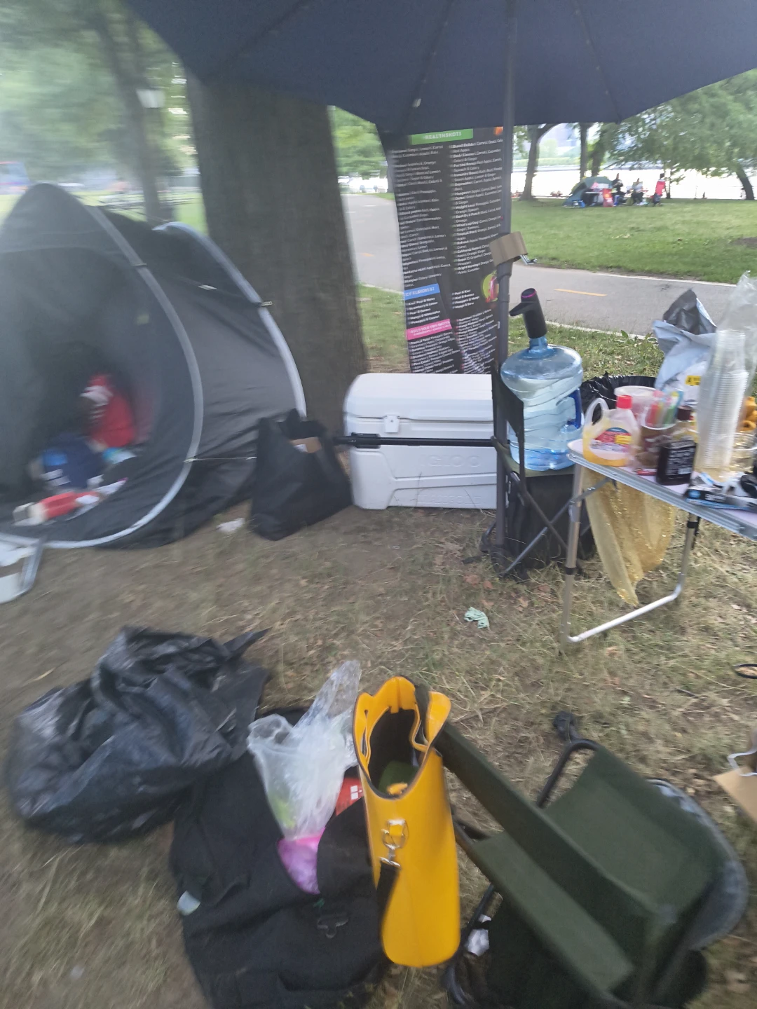 Variety of drinks and cups at outdoor event - photo 4