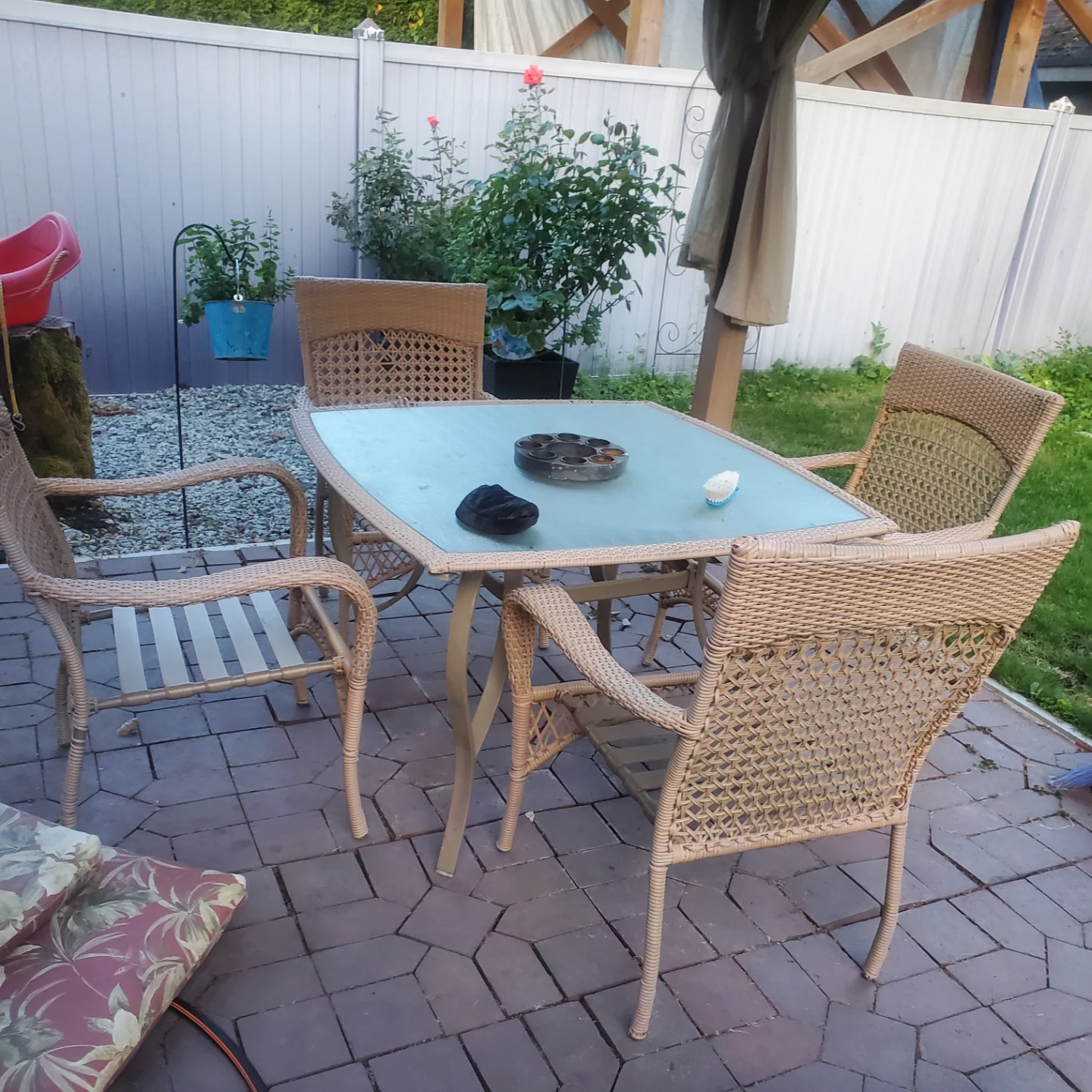 Wicker patio dining set with glass table