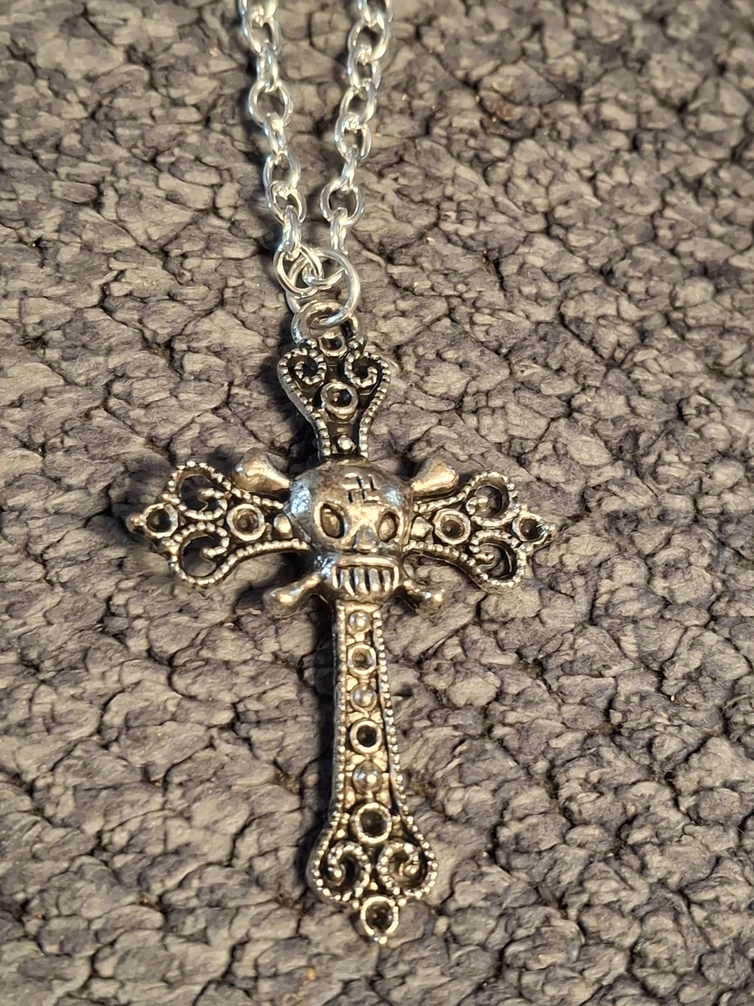 Silver-tone cross necklace with skull detail