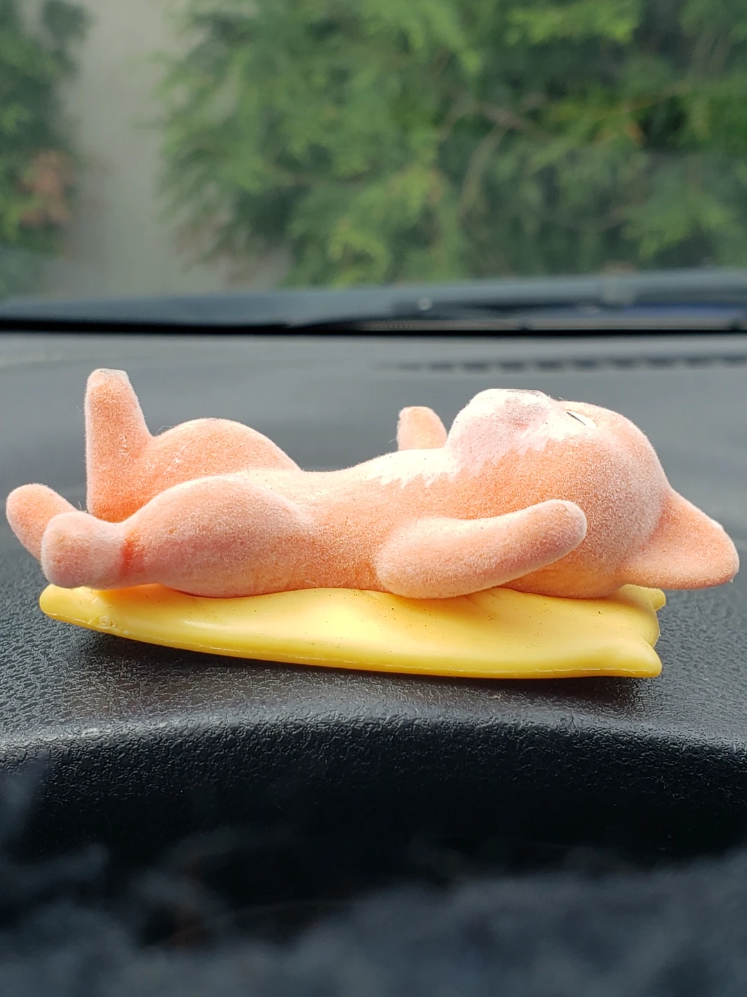 Orange Cat Figurine on Yellow Pillow