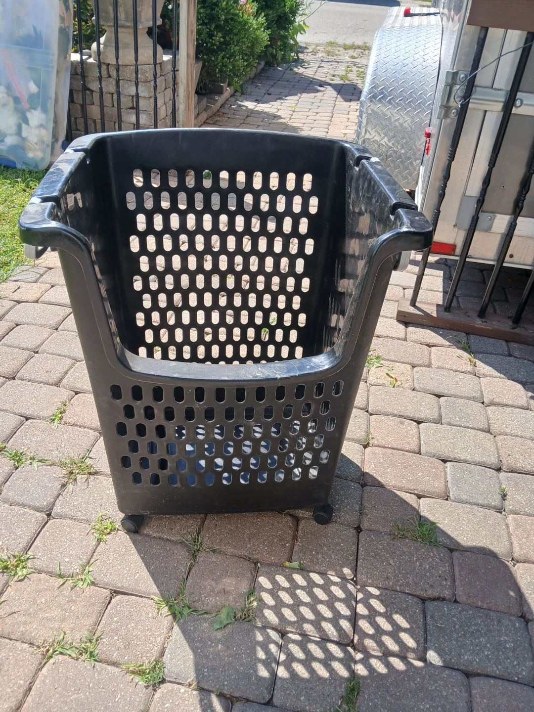 Rolling black plastic storage basket
