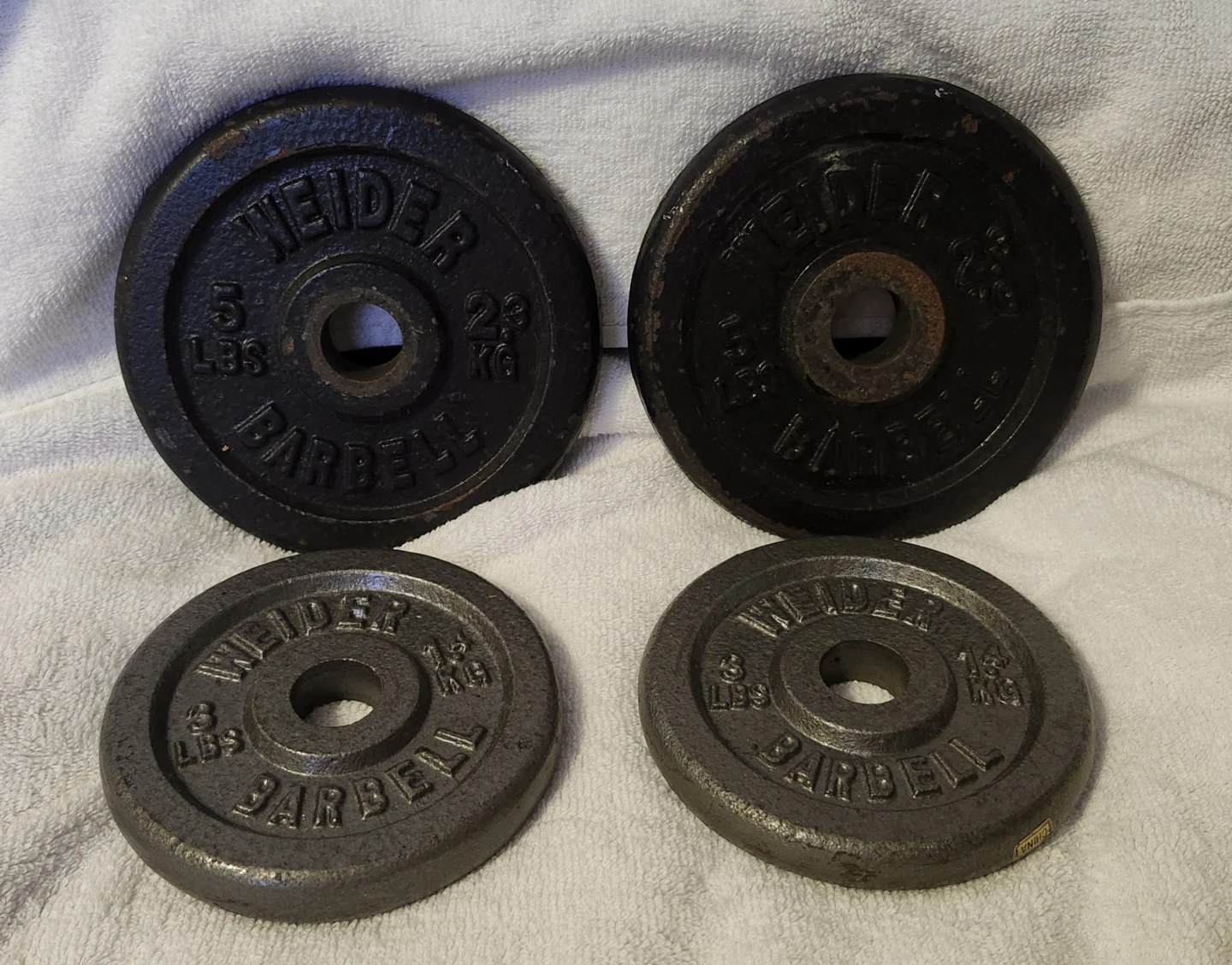 4 Weight Plates 2 Weider 3lbs plates and 2 Weider 5lbs plates