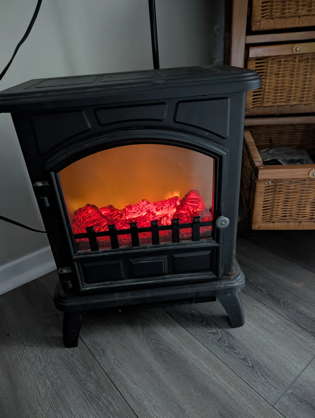 Black electric fireplace with glowing embers