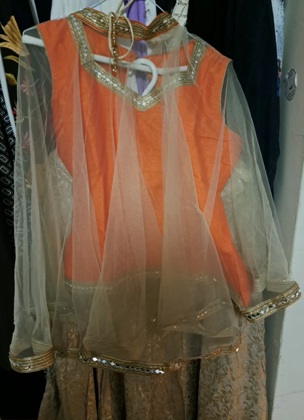 Orange Silk Blend Lehnga, Kurti  and golden net cape