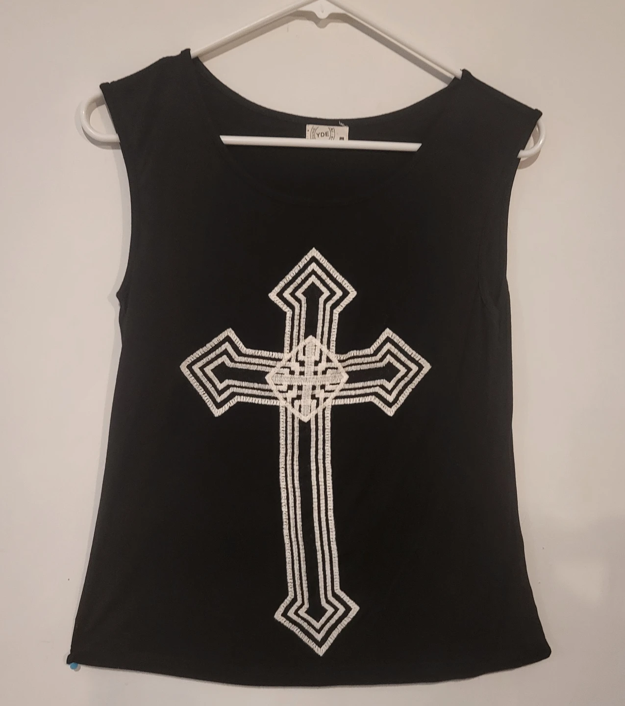 Black sleeveless top with embroidered cross design
