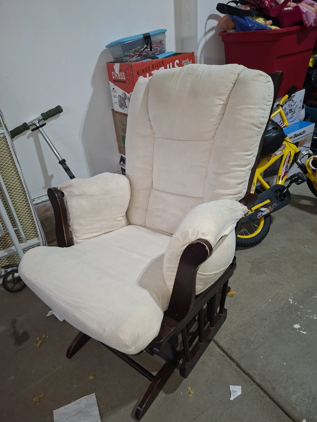 Cream rocking glider chair with dark wood frame