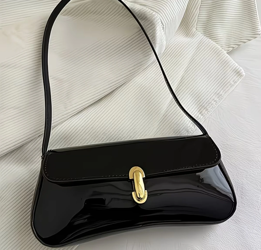 Black patent shoulder bag with gold clasp