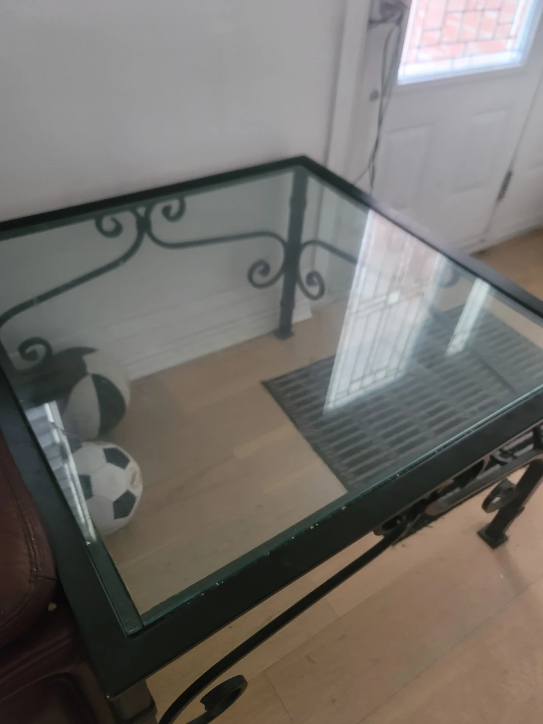 Glass top end table with metal scrollwork