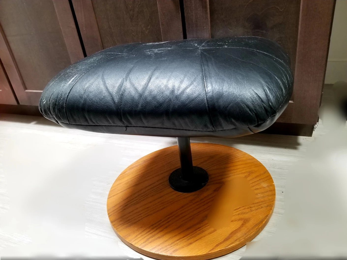 Black leather ottoman with wood base