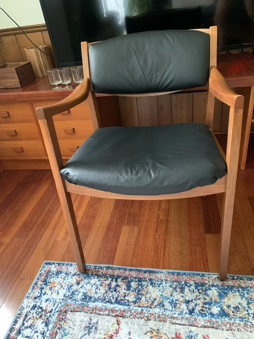 Wooden armchair with black seat