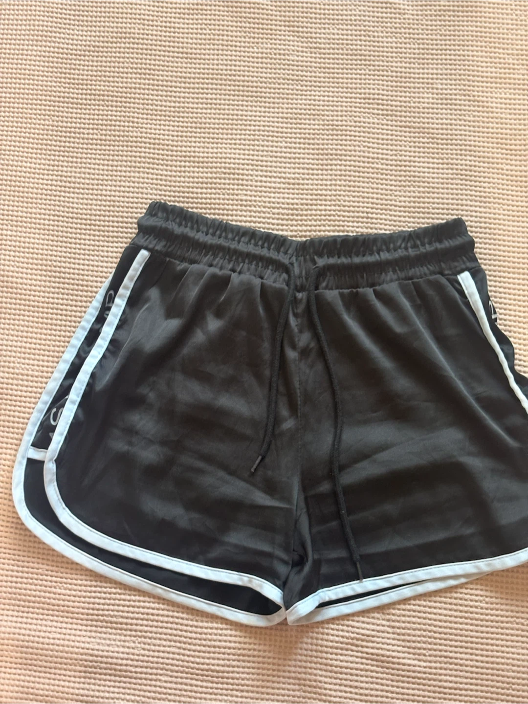 Black athletic shorts with white trim