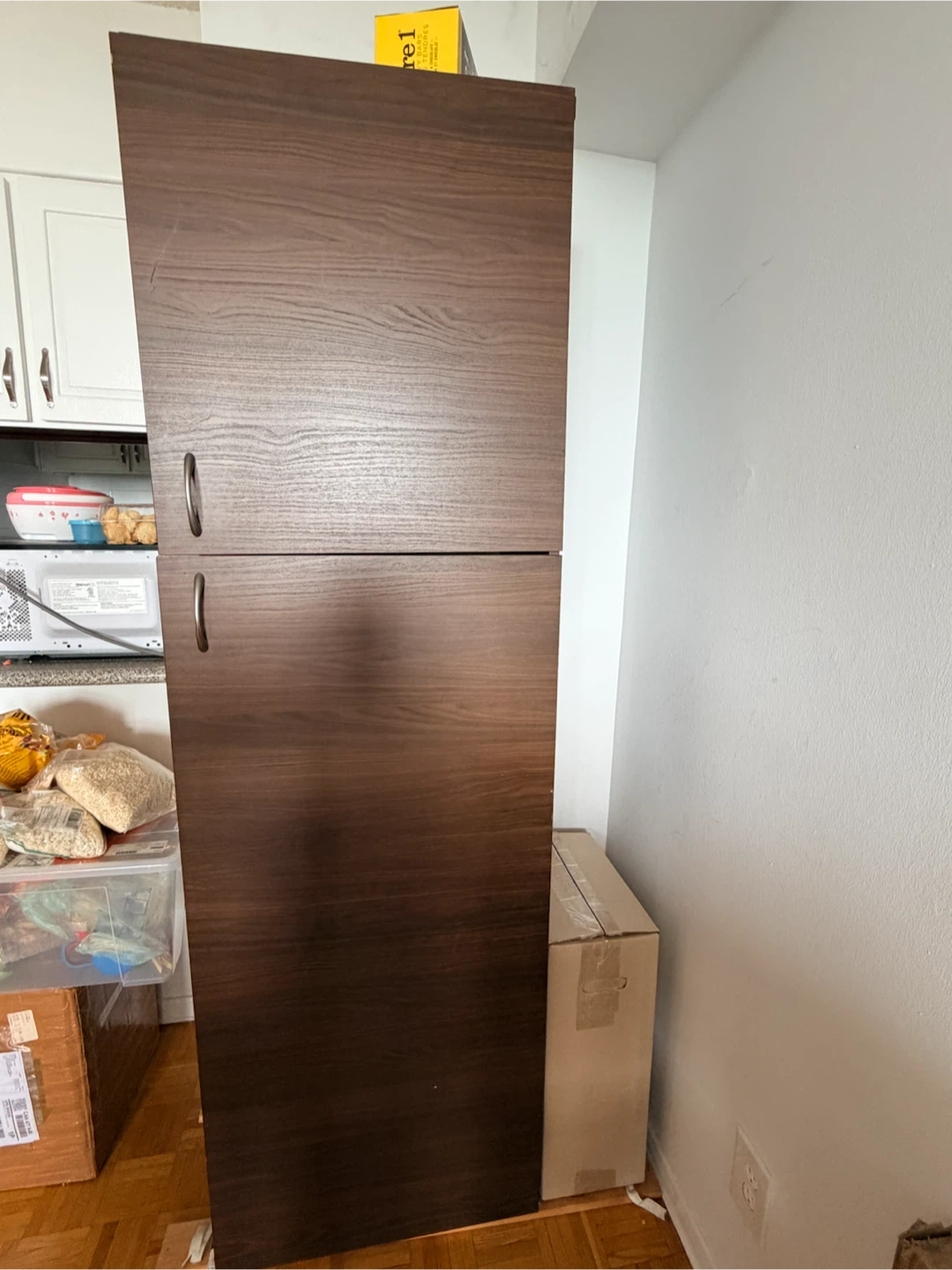 Tall dark brown storage cabinet with shelves