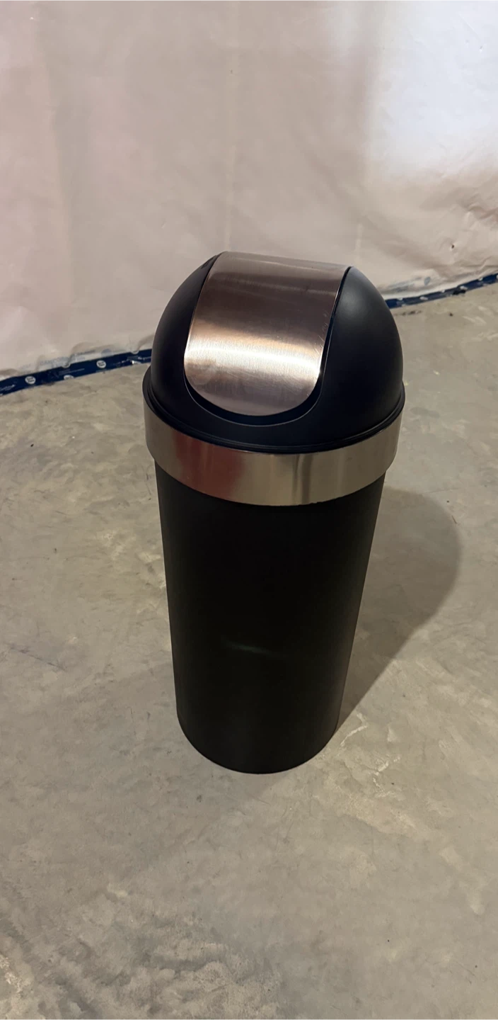 Black waste bin with swing lid