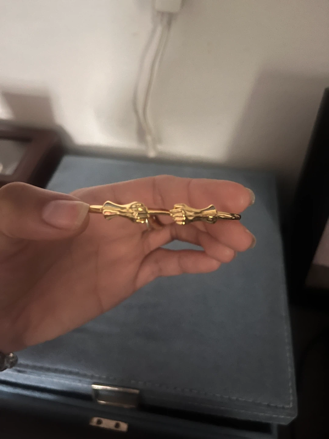 Gold-tone cuff bracelet with hand details