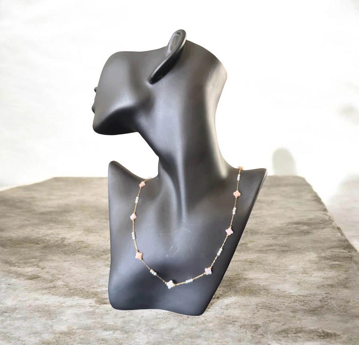 Gold-tone necklace with pink clover  and pearl beads