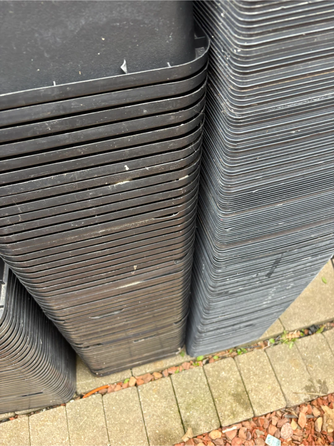 Stack of black plastic planters