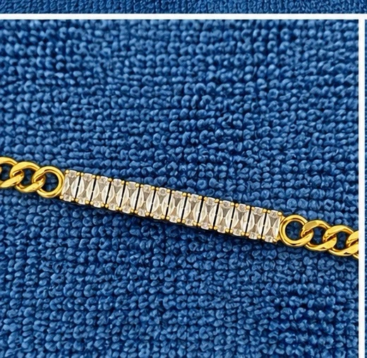 Gold tone bracelet with clear stones