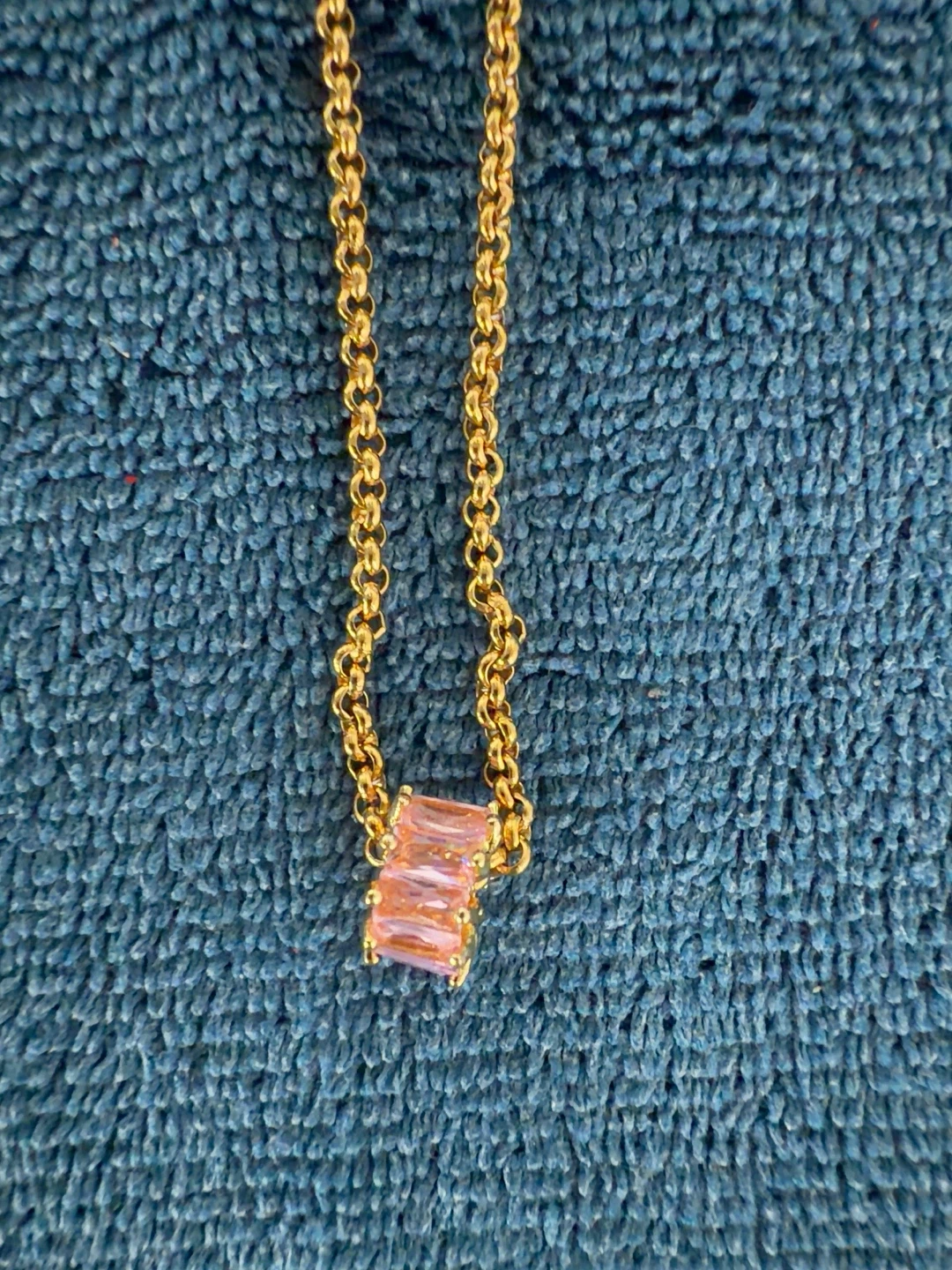 Gold-tone necklace with pink rectangular stone pendant