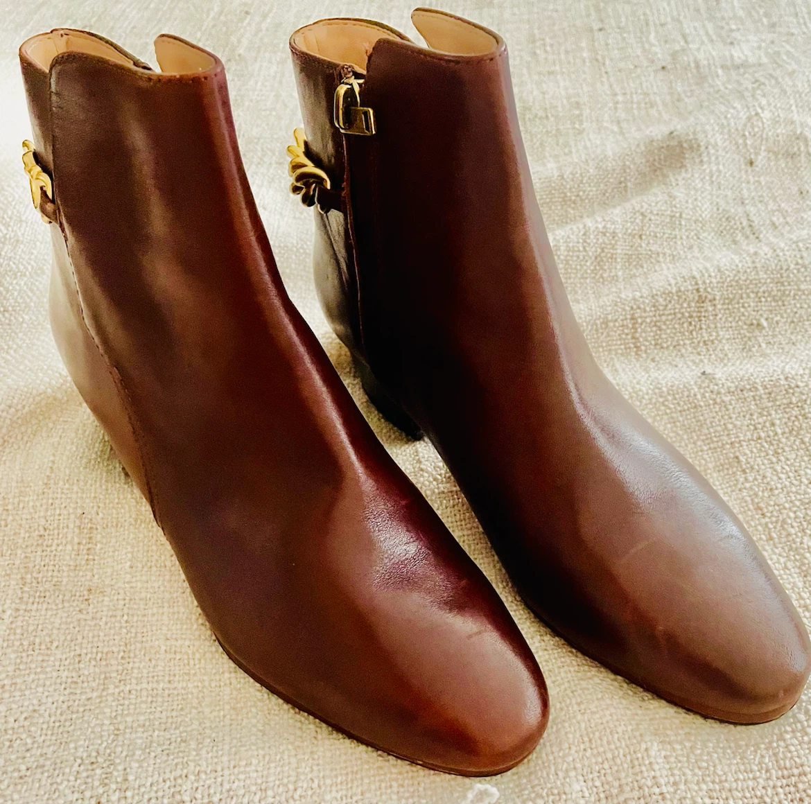 Brown leather ankle boots with gold chain detail