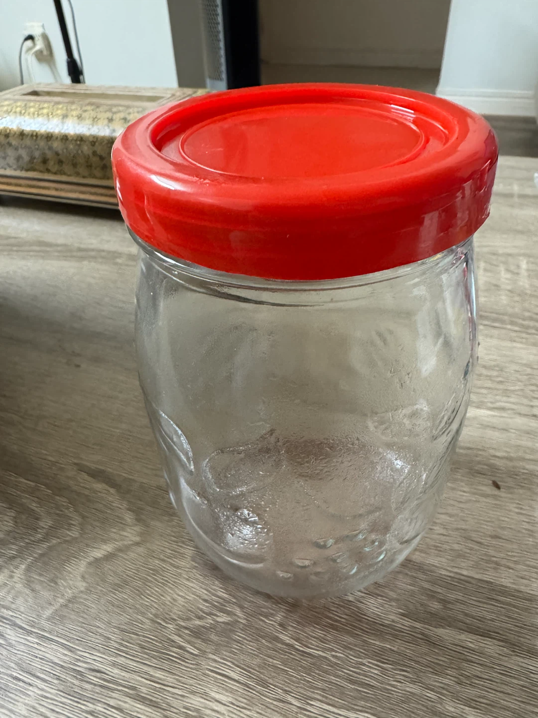 Glass jar with red lid
