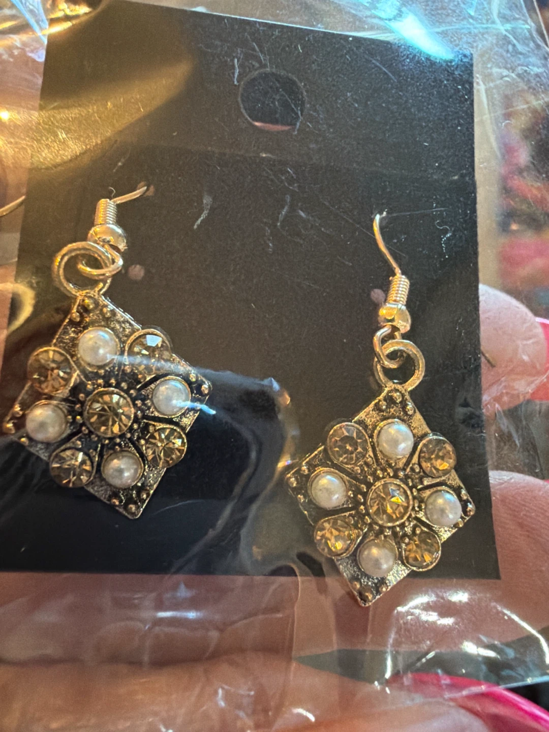 Gold tone dangle earrings with faux pearls and rhinestones