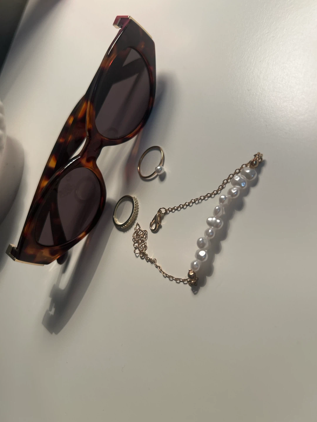Tortoiseshell Sunglasses with Pearl Bracelet and Rings