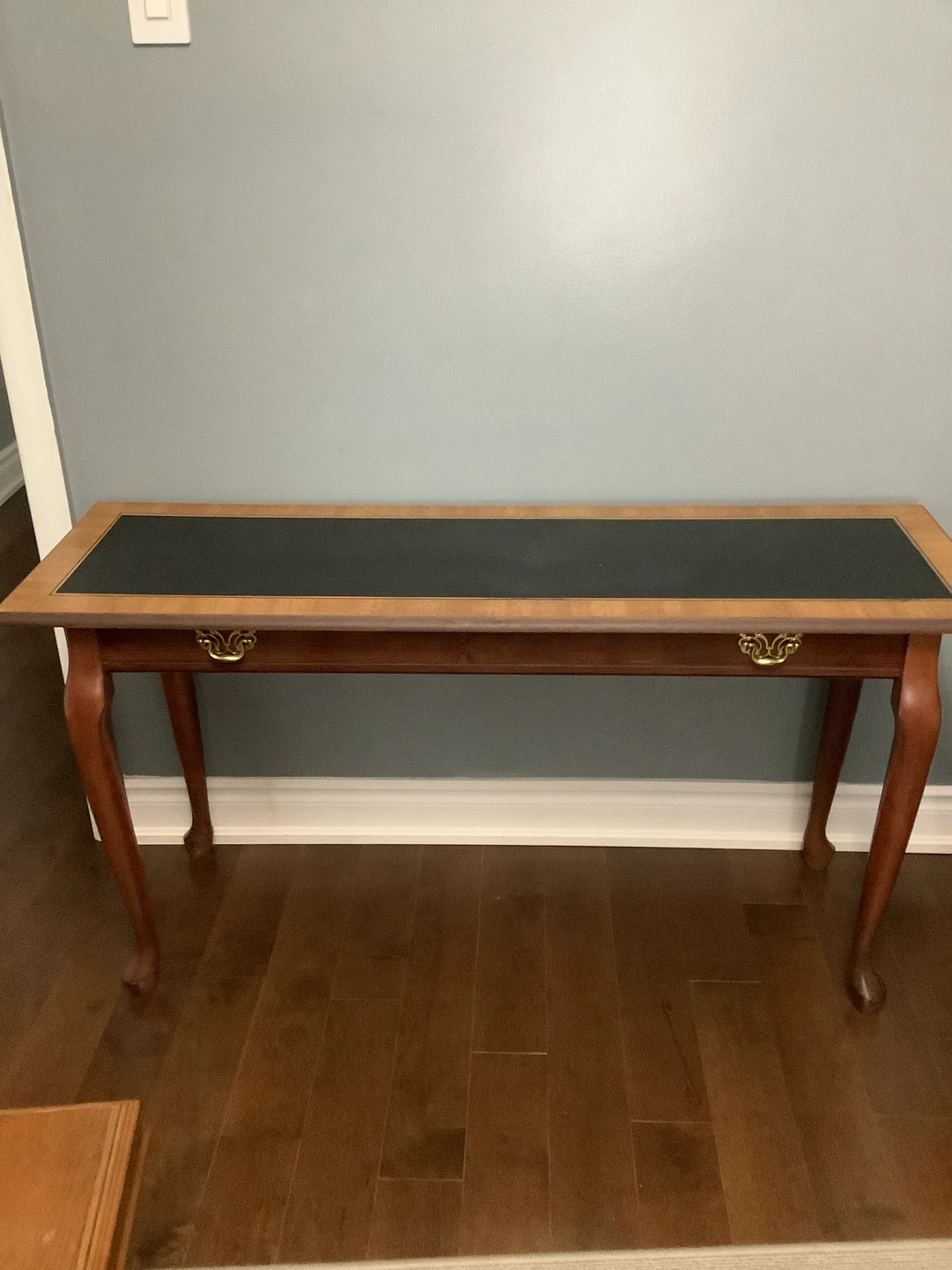 Console table with black top and wooden legs