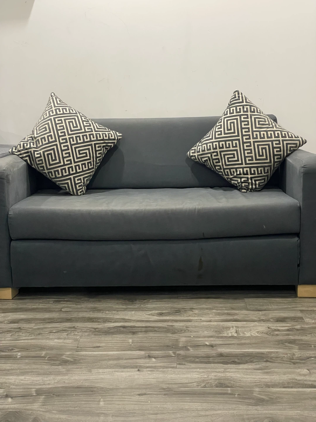 Dark Grey Sofa Bed with Two Throw Pillows