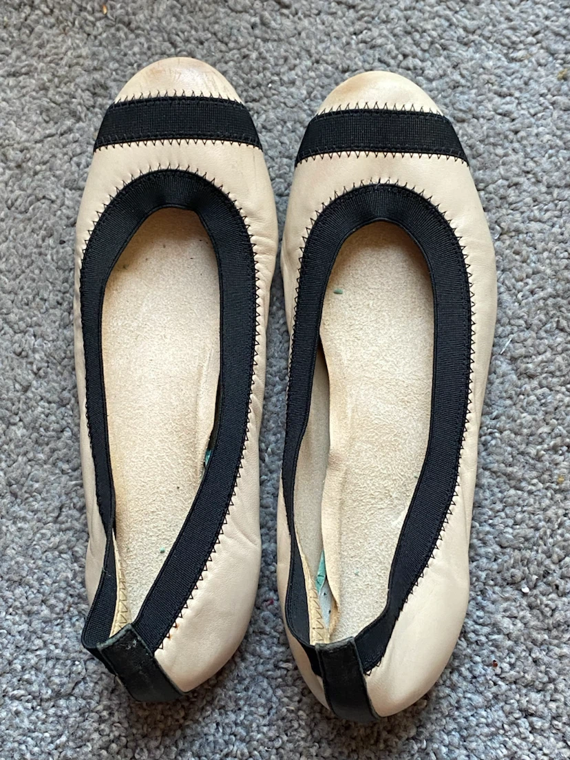 Beige ballet flats with black trim