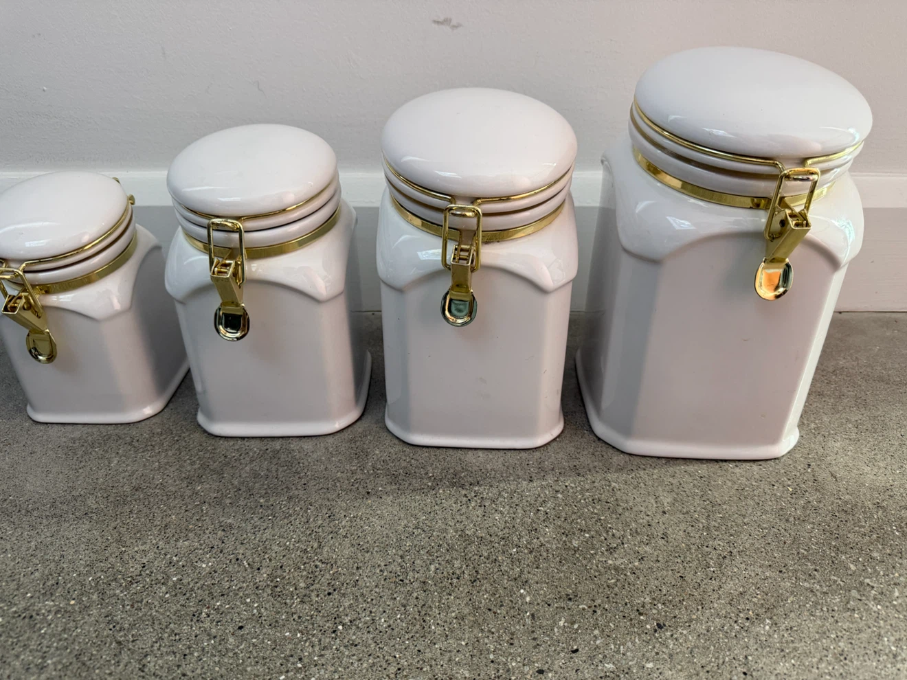 Set of 4 White Ceramic Canisters with Gold Accents