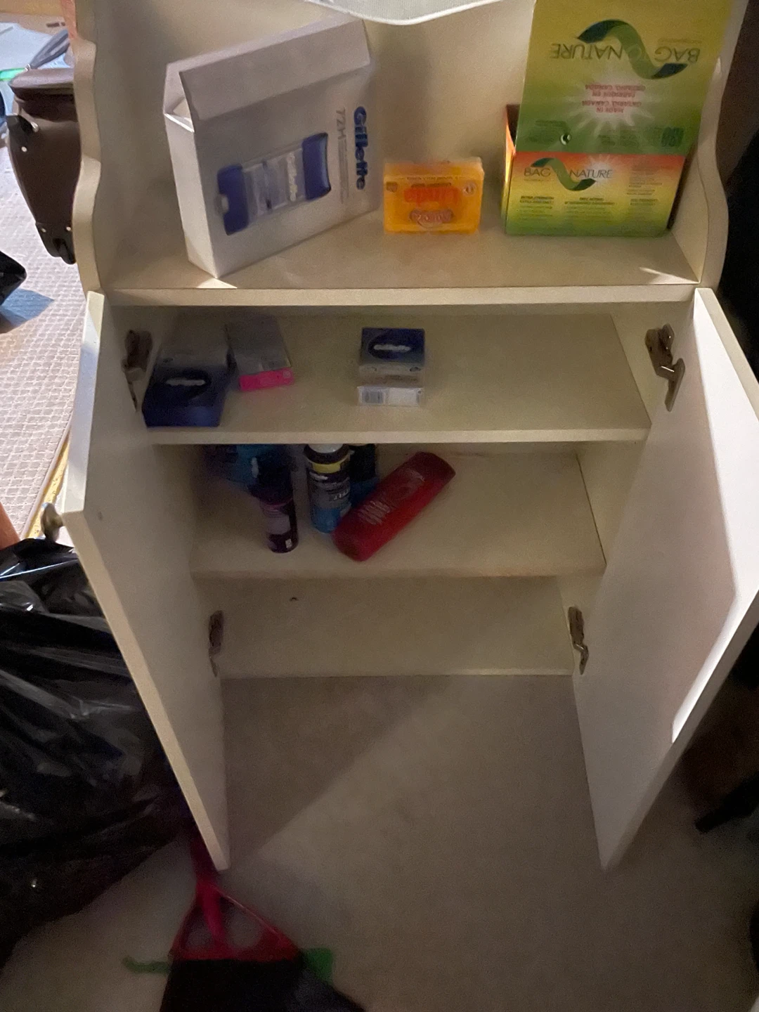 Cream coloured storage cabinet with shelves