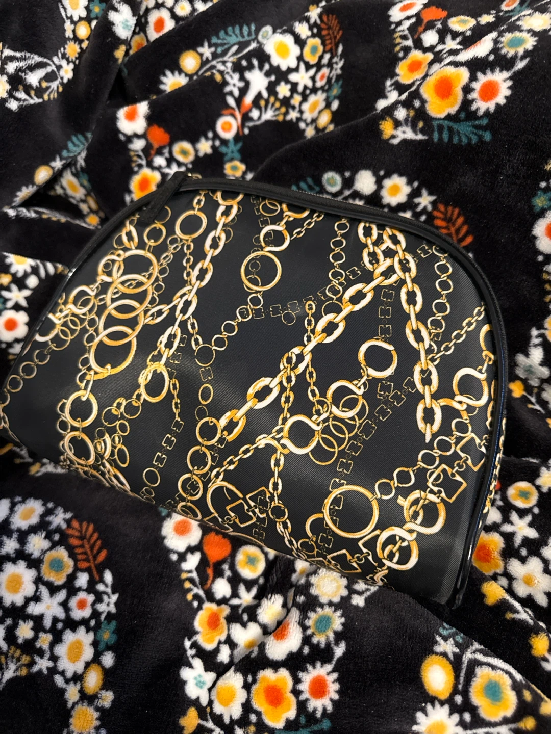 Black cosmetic bag with gold chain print