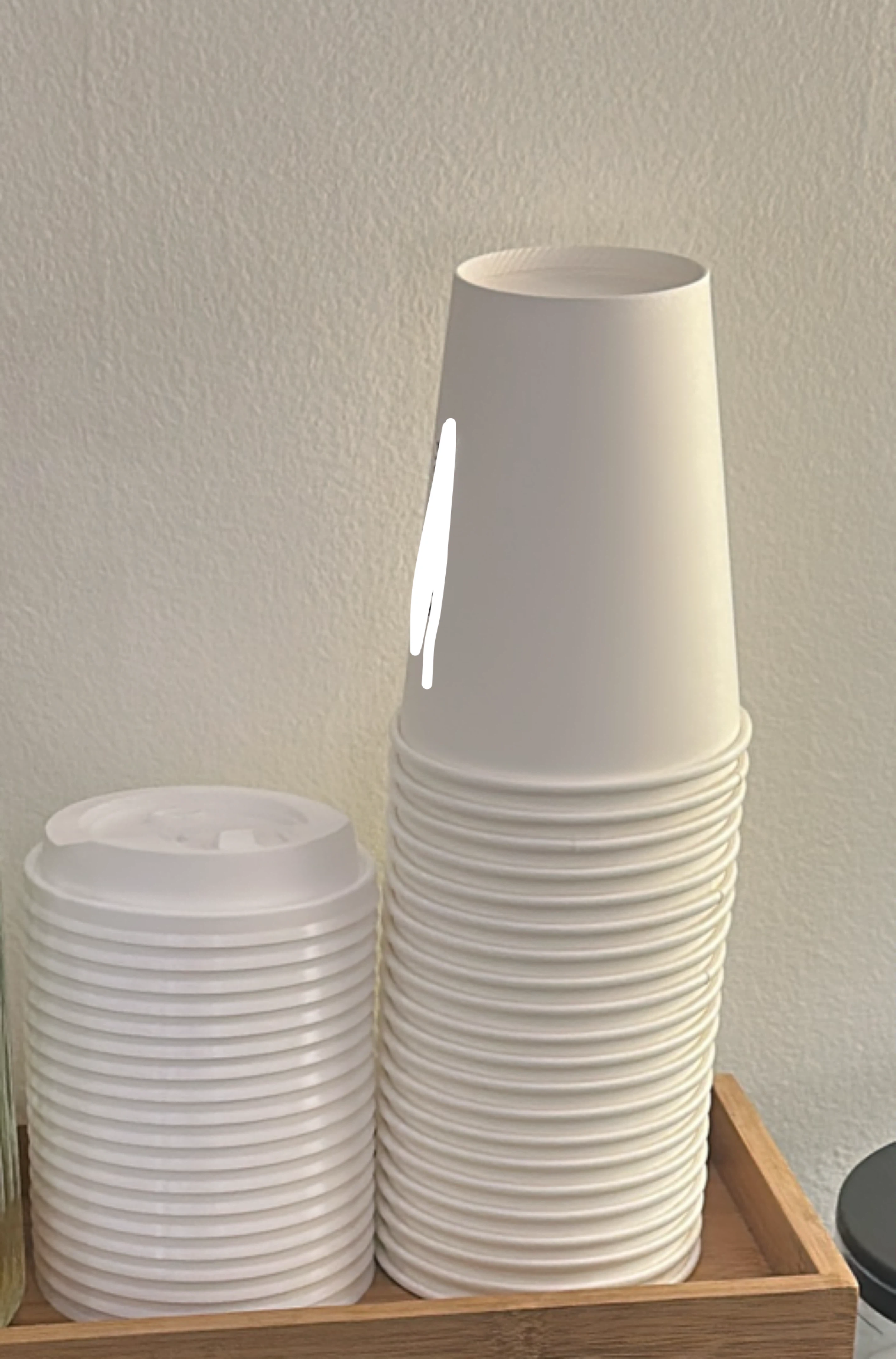 Stack of White Paper Coffee Cups with Lids