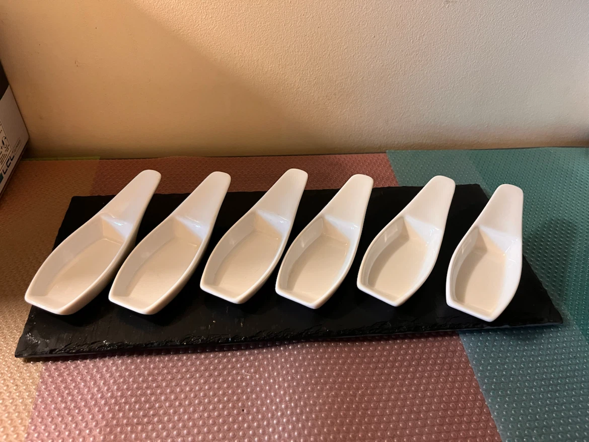 Set of 6 White Ceramic Tasting Spoons on black stone