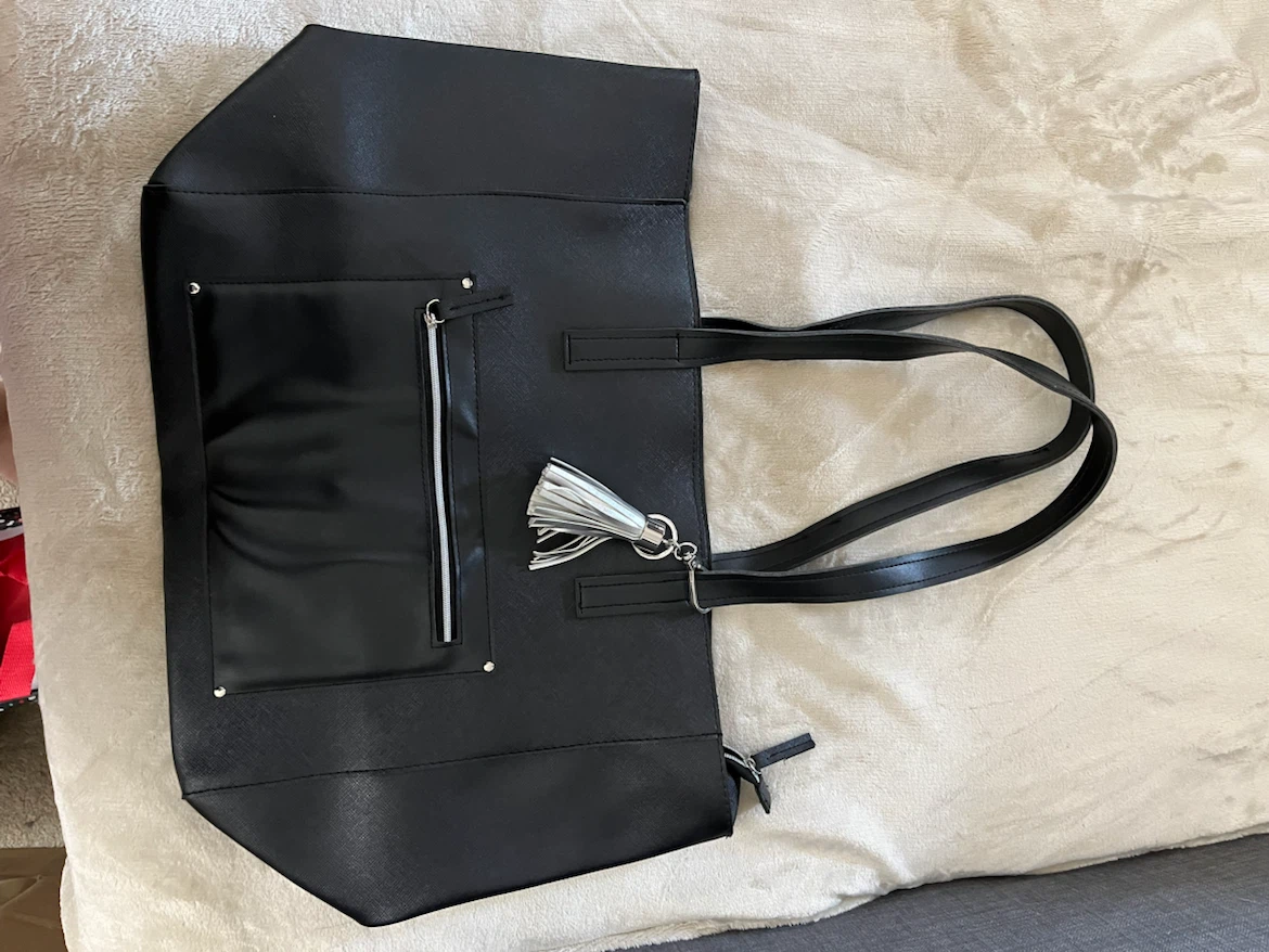 Black tote bag with vinyl tassel keychain