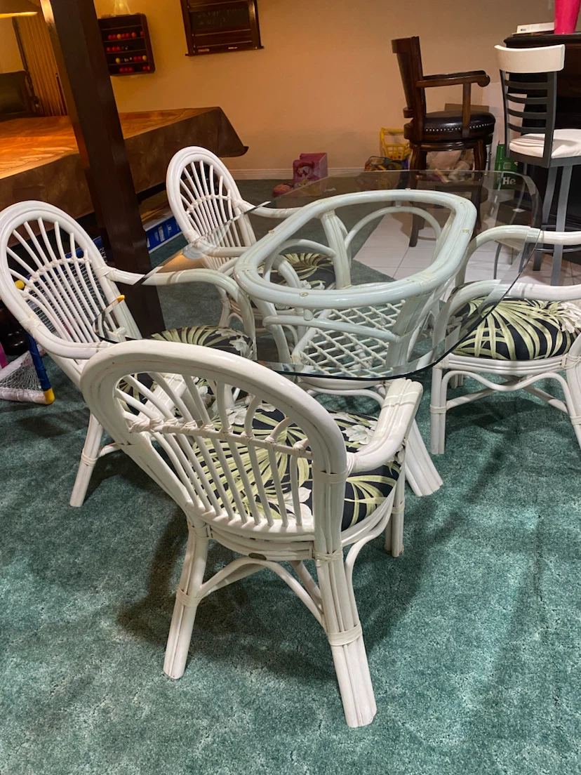 White Rattan Dining Set with Glass Top and Floral Cushions