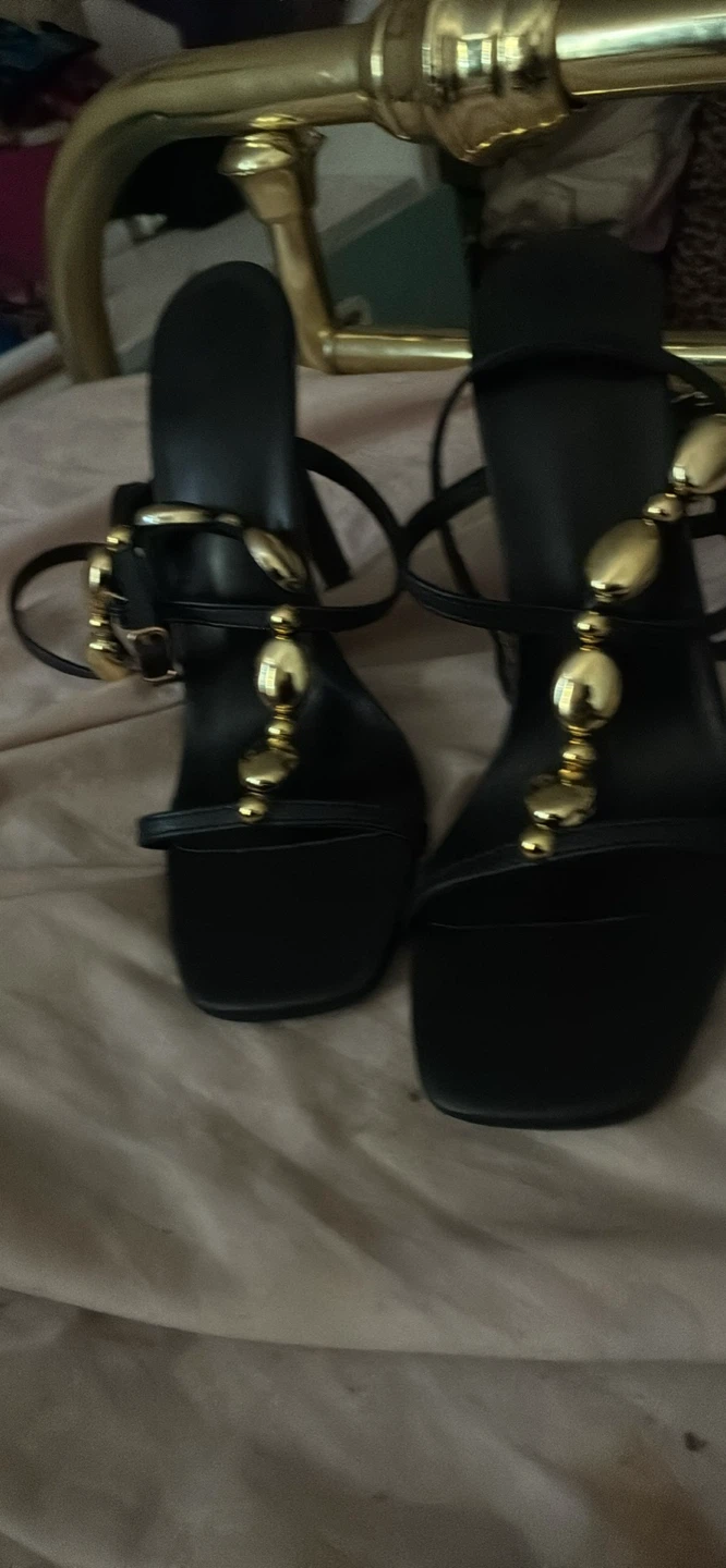 Black heeled sandals with gold embellishments