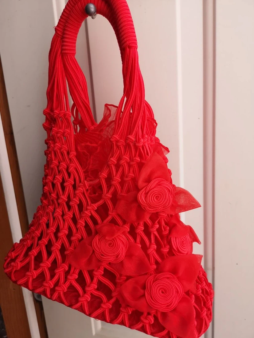 Red macrame tote bag with floral accents