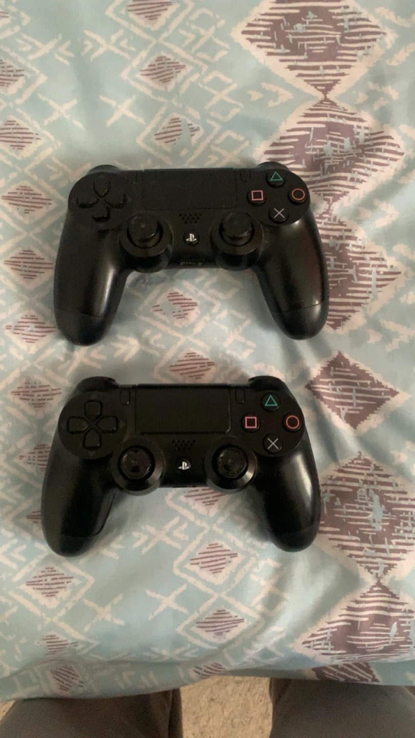 Two Black Sony PlayStation 4 Controllers