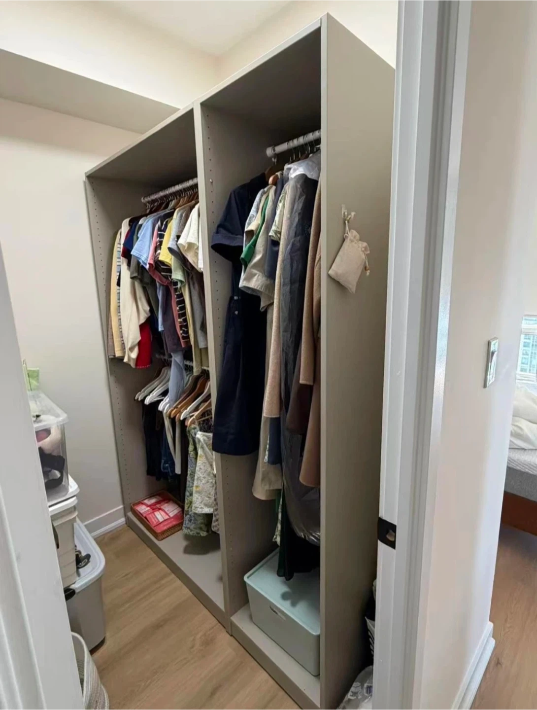 Cream coloured closet organizer with hanging rod