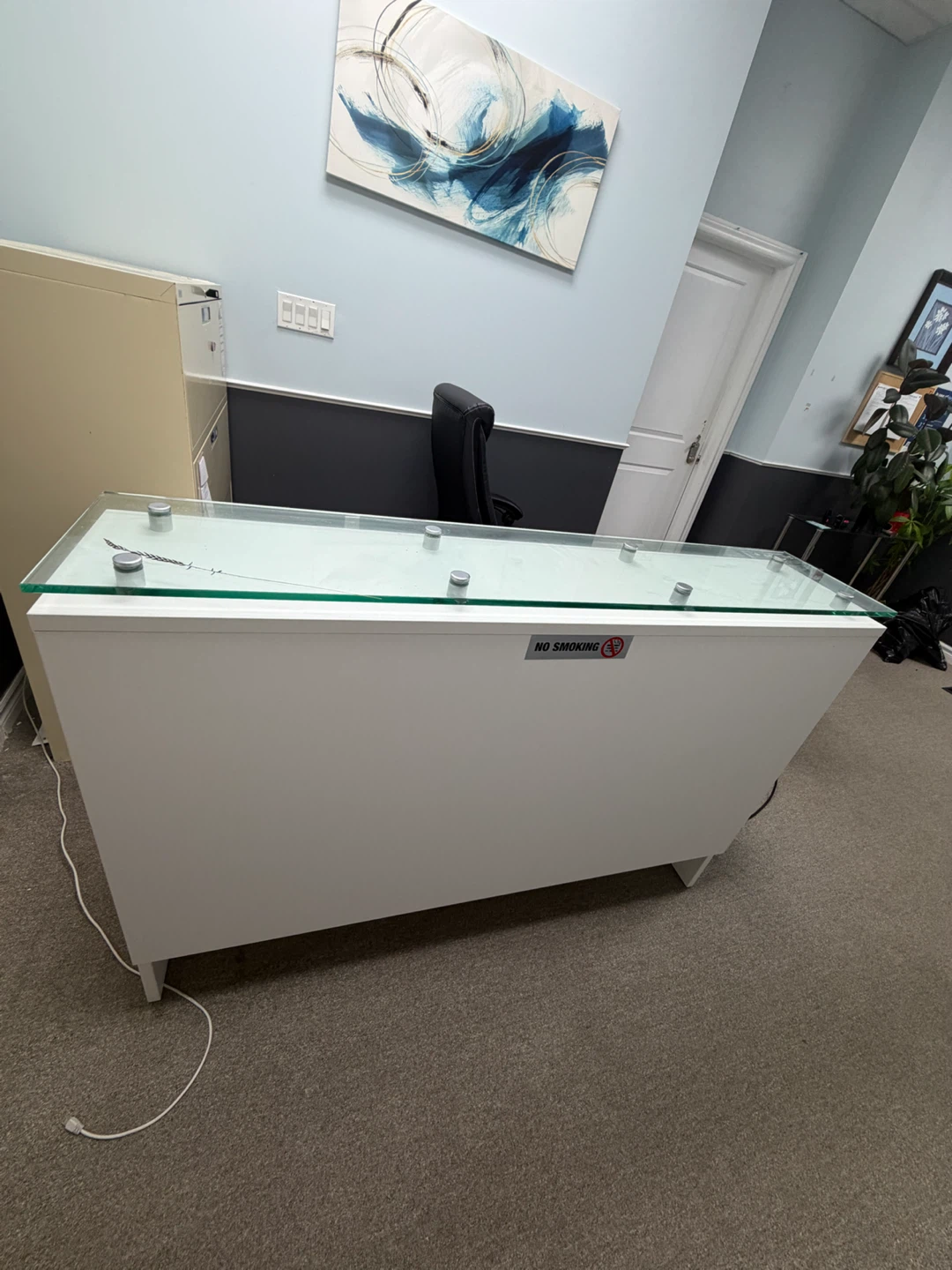 White reception desk with glass top
